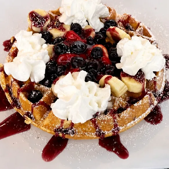 Loaded waffle with strawberries, bananas and blueberries